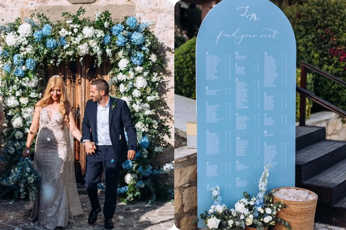 Couple leaving a stone church with blue and white floral decoration and a seating chart