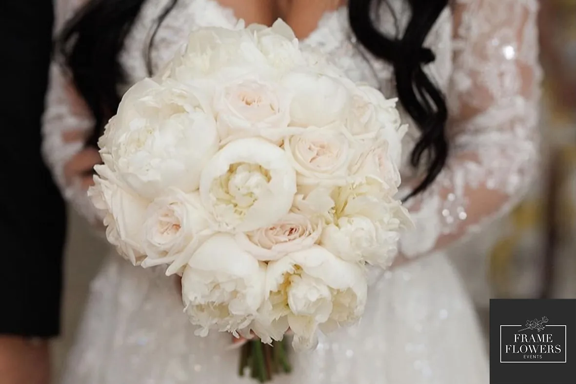 Bridal bouquet of white peonies and roses